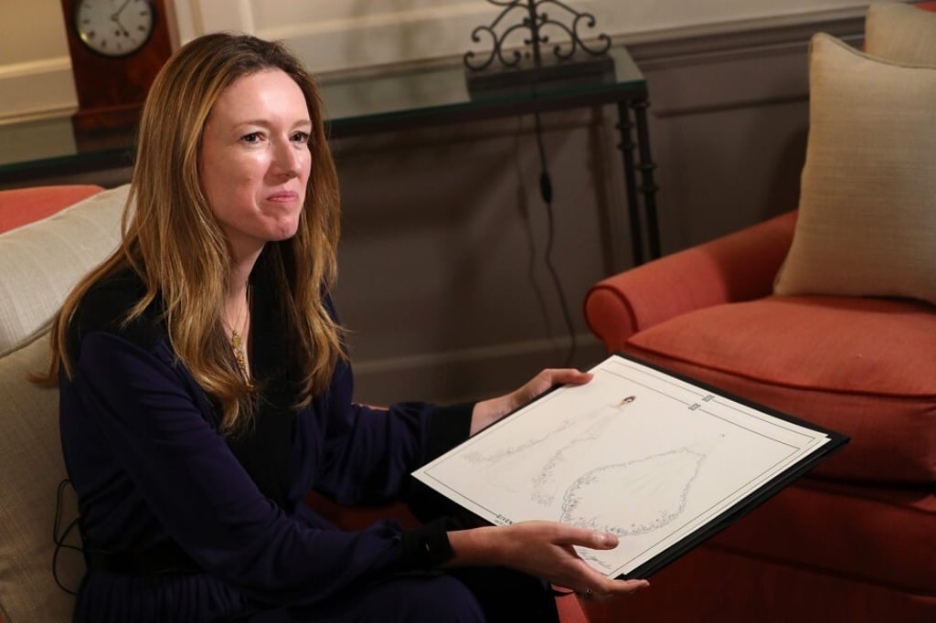 Clare Waight Keller shows off her dress sketches for Meghan Markle’s dress, a day after the royal wedding in May in 2018. Photo: AFP pool