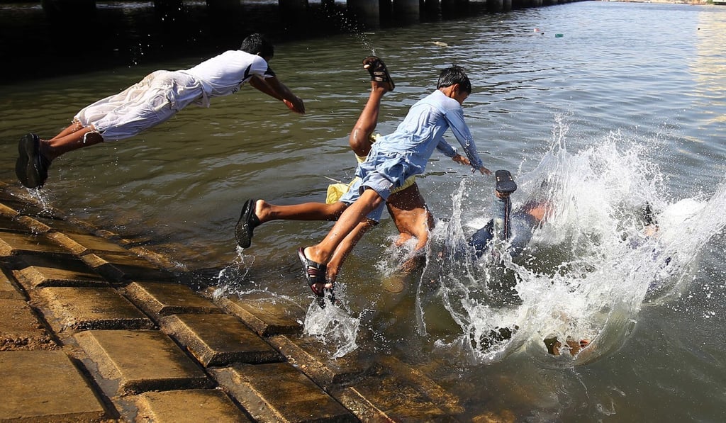 Children in Karachi, Pakistan, play in water to beat the heat during the Muslim holy month of Ramadan. Photo: EPA