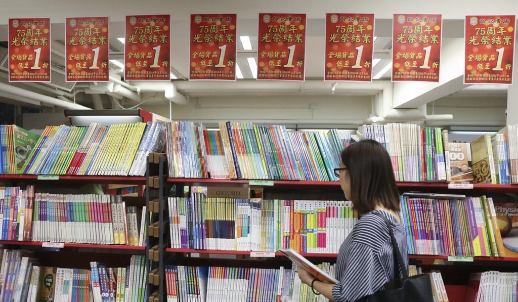 A woman browses books at the closing sale of Ling Kee Book Store, one of Hong Kong's oldest booksellers, on November 8, 2019. Photo: K.Y. Cheng