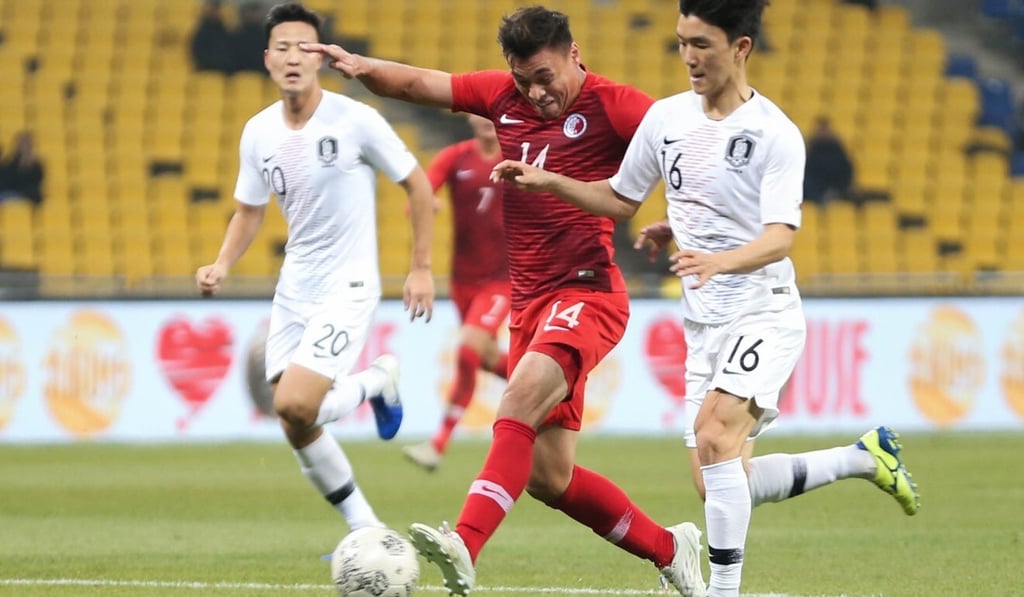 James Ha of Hong Kong (middle) attempts to break away from his Korean markers at the 2019 EAFF Championship in Busan. Photo: HKFA
