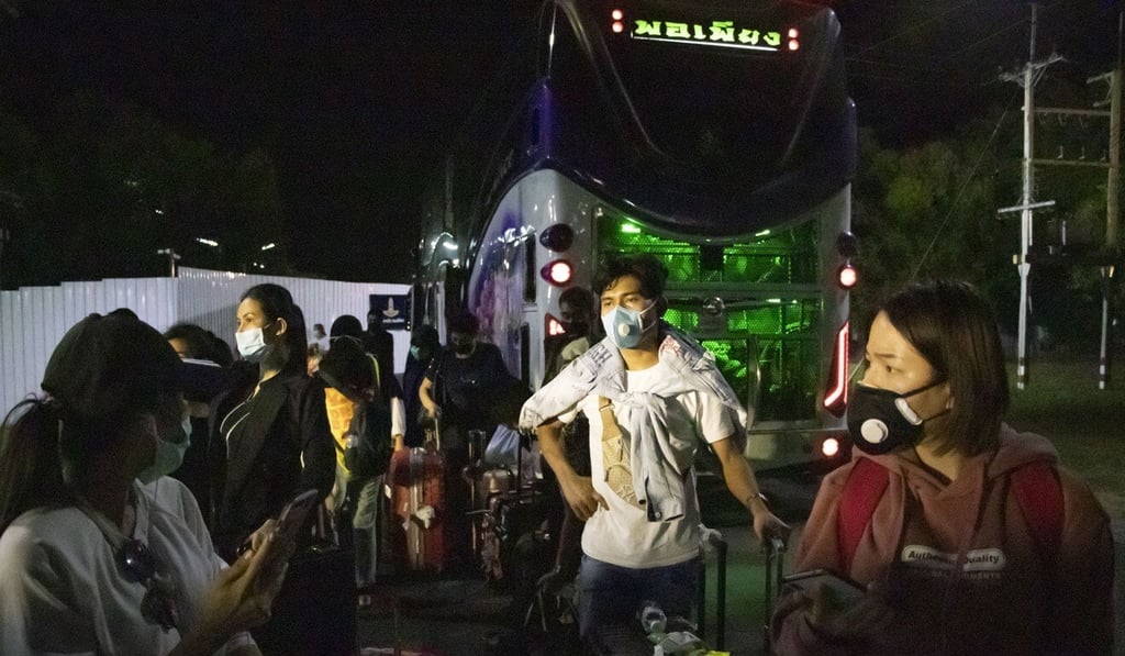 Newly arrived Thai passengers from Jakarta, Indonesia, gather their luggage and wait to be processed at the barracks of the Royal Thai Air Force Flight Training School. Photo: Charles Dharapak