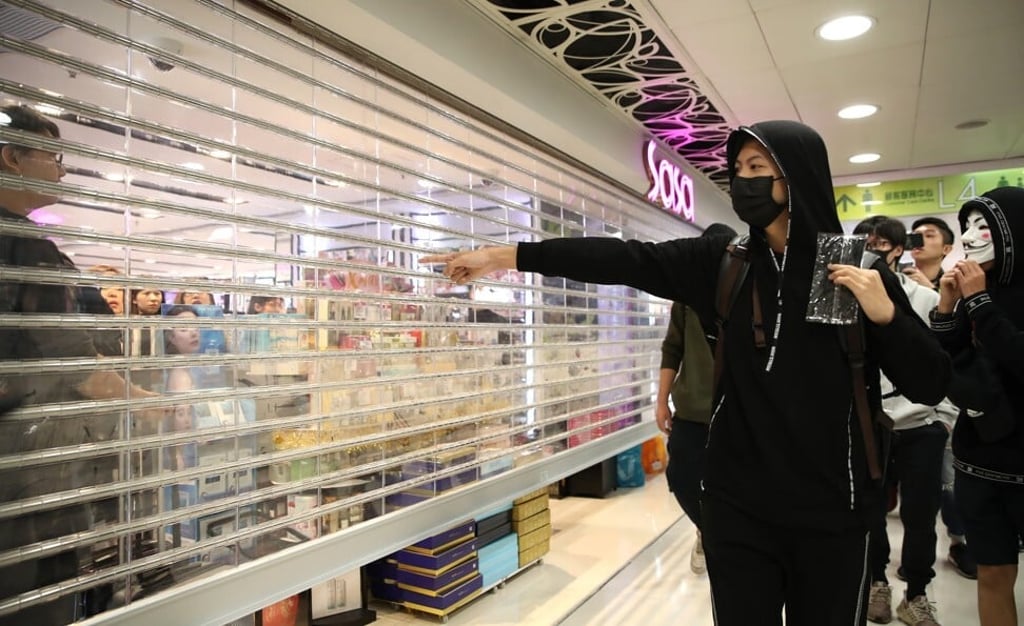A Sasa cosmetics shop shuts the gate while anti-government protesters stages a 'shopping' protest at the Landmark North shopping centre in Sheung Shui. Photo: Winson Wong
