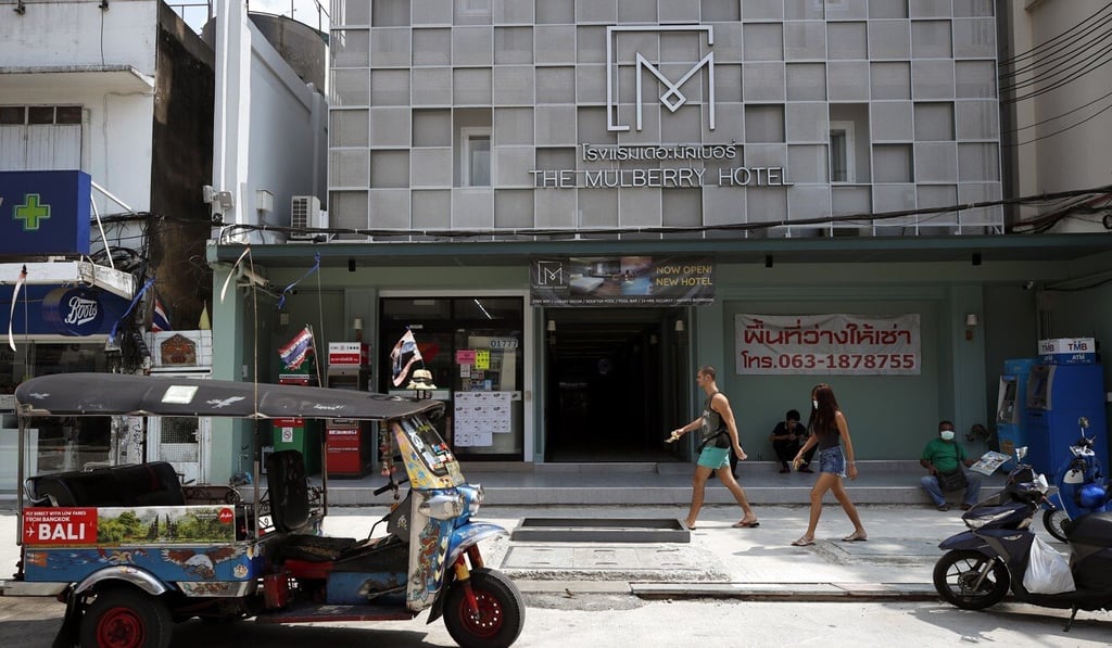 Tourists walk past a hotel in Bangkok’s deserted Khaosan Road. Photo: EPA