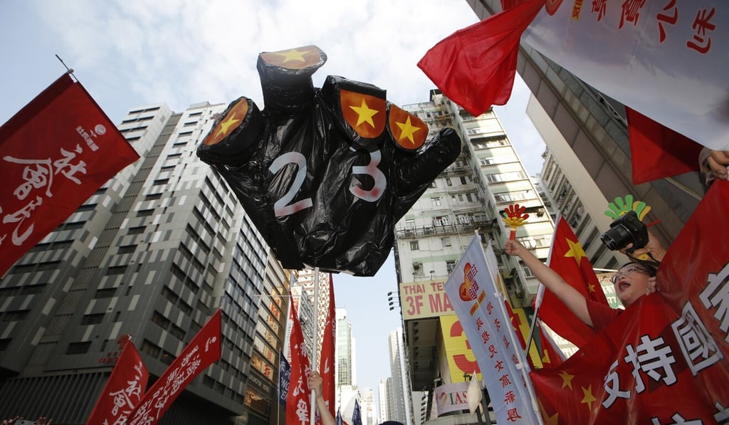 Pro-democracy protesters hold a mock black hand with the number '23', meant to symbolise Article 23 of Hong Kong’s Basic Law, which requires the passage of a national security law. Photo: AP