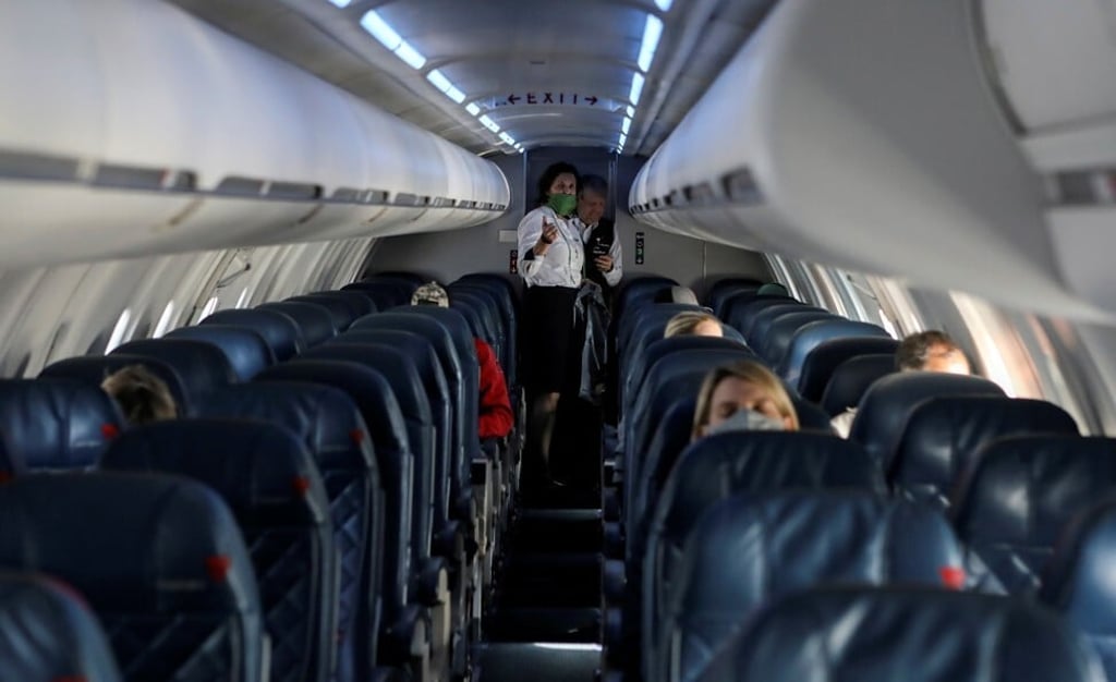 Flight attendants talk on a sparsely populated flight. Photo: Reuters