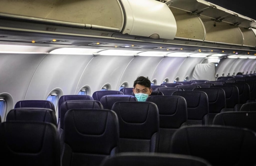 A passenger sits in a mostly empty plane on a flight from Sihanoukville, Cambodia to Guangzhou, China. Photo: EPA-EFE