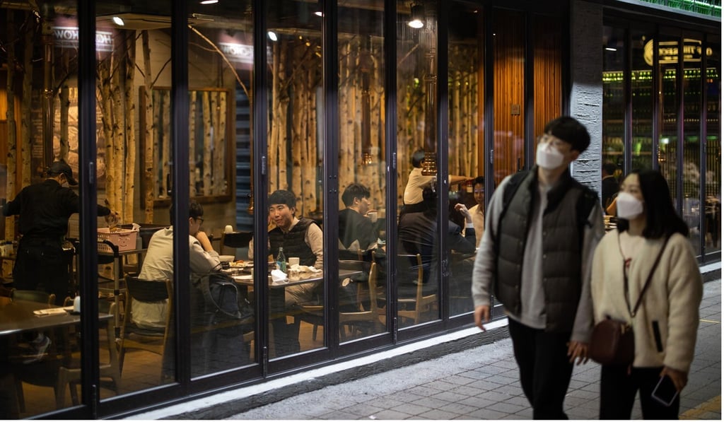 People walk past a restaurant at night in the Itaewon district in Seoul. Photo: Bloomberg