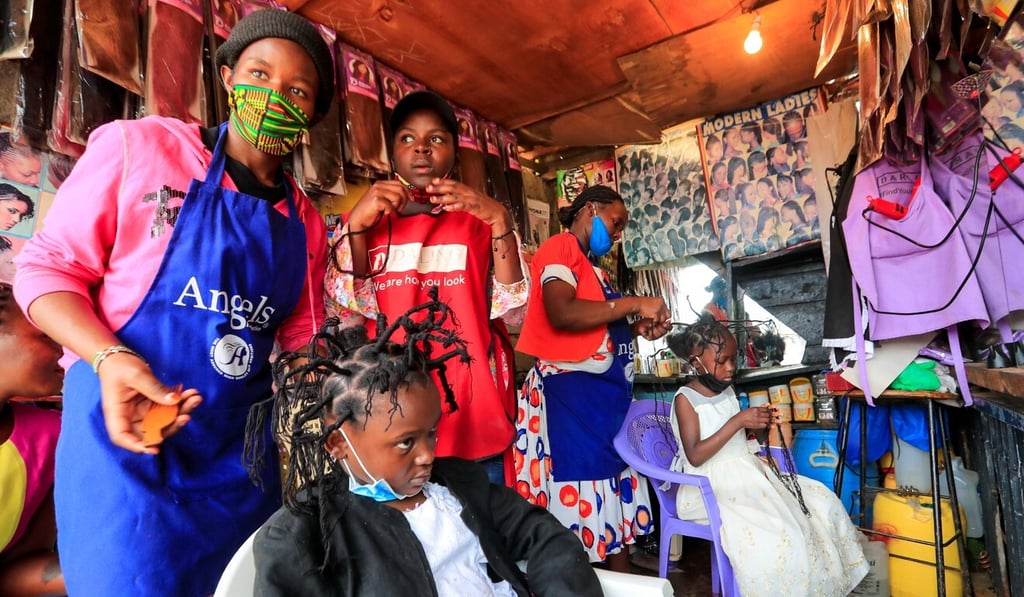Martha Apisa, 12, and Stacy Ayuma, eight, are given the coronavirus hairstyle at Mama Brayo Beauty Salon in the Kibera slum in Nairobi, Kenya. Photo: Reuters Martha Apisa, 12, and Stacy Ayuma, eight, are given the coronavirus hairstyle at Mama Brayo Beauty Salon in the Kibera slum in Nairobi, Kenya. Photo: Reuters
