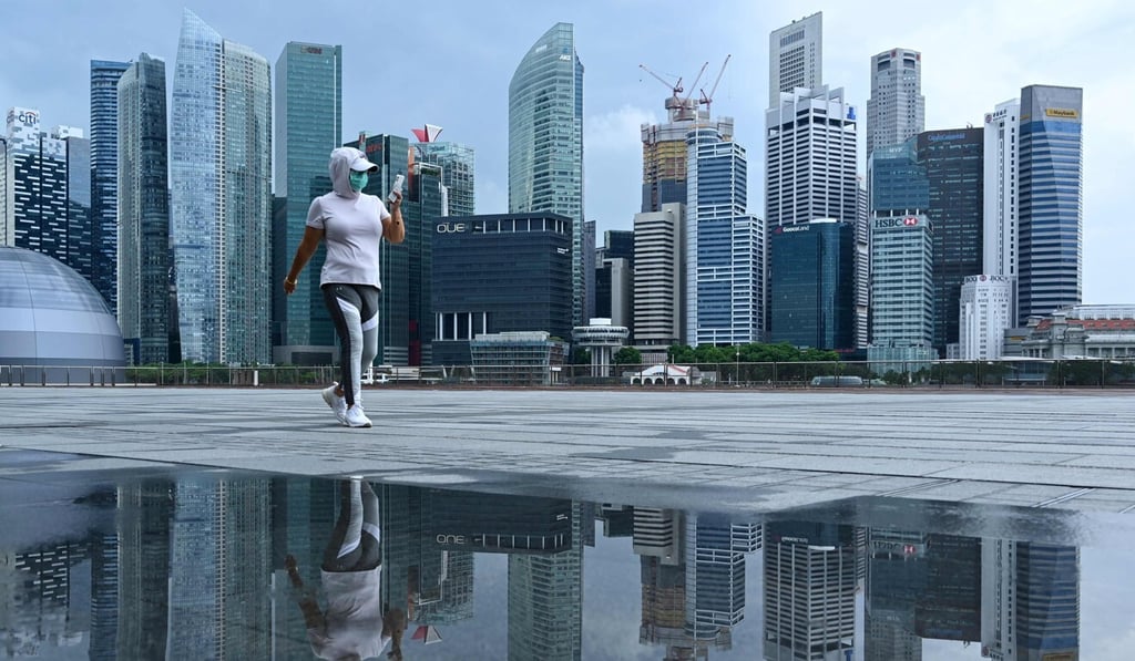 A woman walks along the promenade at Marina Bay in Singapore on May 4. Photo: AFP