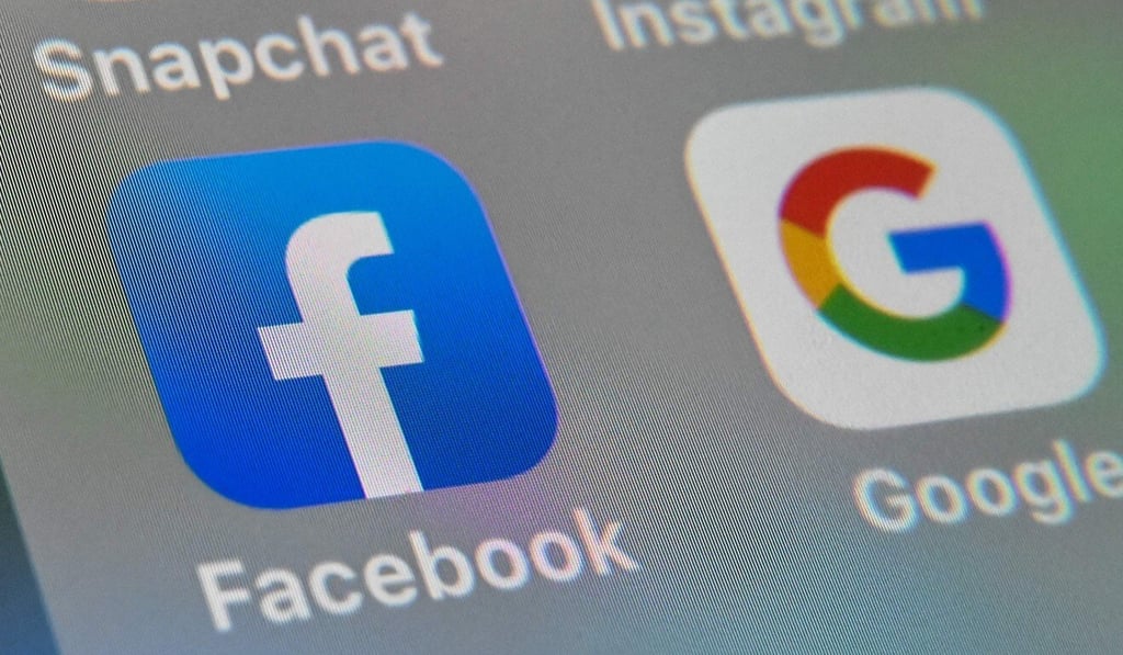 The logos of mobile apps Facebook and Google displayed on a tablet in Lille, France. Photo: AFP The logos of mobile apps Facebook and Google displayed on a tablet in Lille, France. Photo: AFP