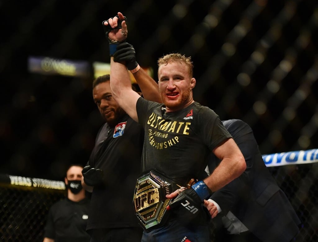 Dana White puts the interim lightweight title belt on Justin Gaethje.