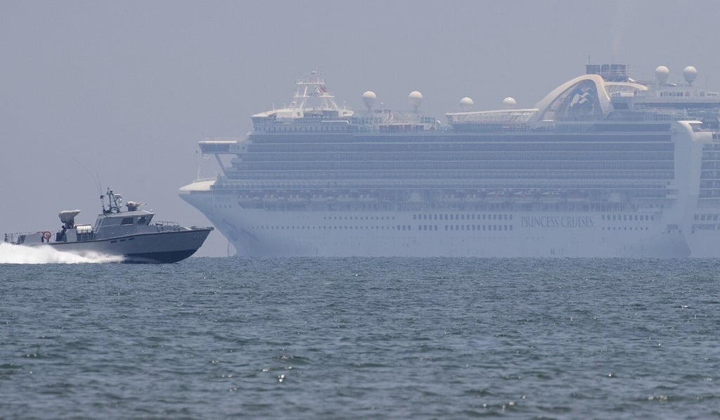 A Philippine military boat passes by the cruise ship Ruby Princess in Manila Bay. Photo: AP