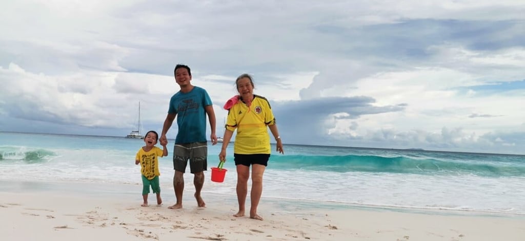 Rex Yang (centre), nephew George Yang (left) and his mother Subi Zhou enjoy a day on the beach in the Seychelles.