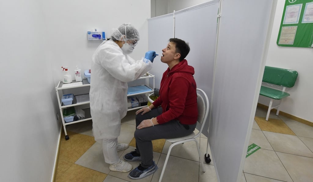 A health worker takes a sample from a man at a drive-in Covid-19 testing facility in Moscow. Photo: AFP A health worker takes a sample from a man at a drive-in Covid-19 testing facility in Moscow. Photo: AFP