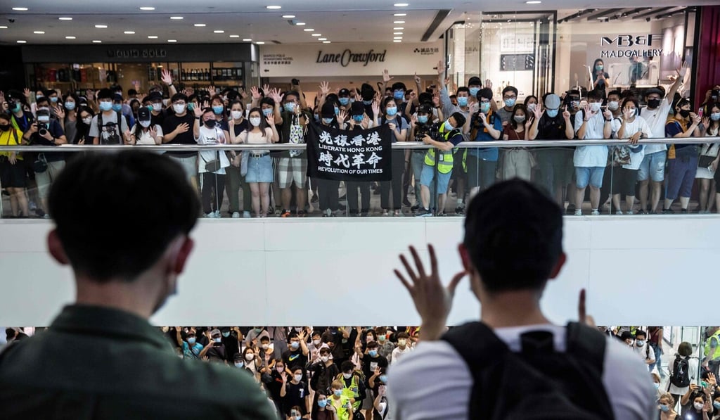 Demonstrators chant anti-government slogans at a Hong Kong mall on Monday. Photo: AFP Demonstrators chant anti-government slogans at a Hong Kong mall on Monday. Photo: AFP