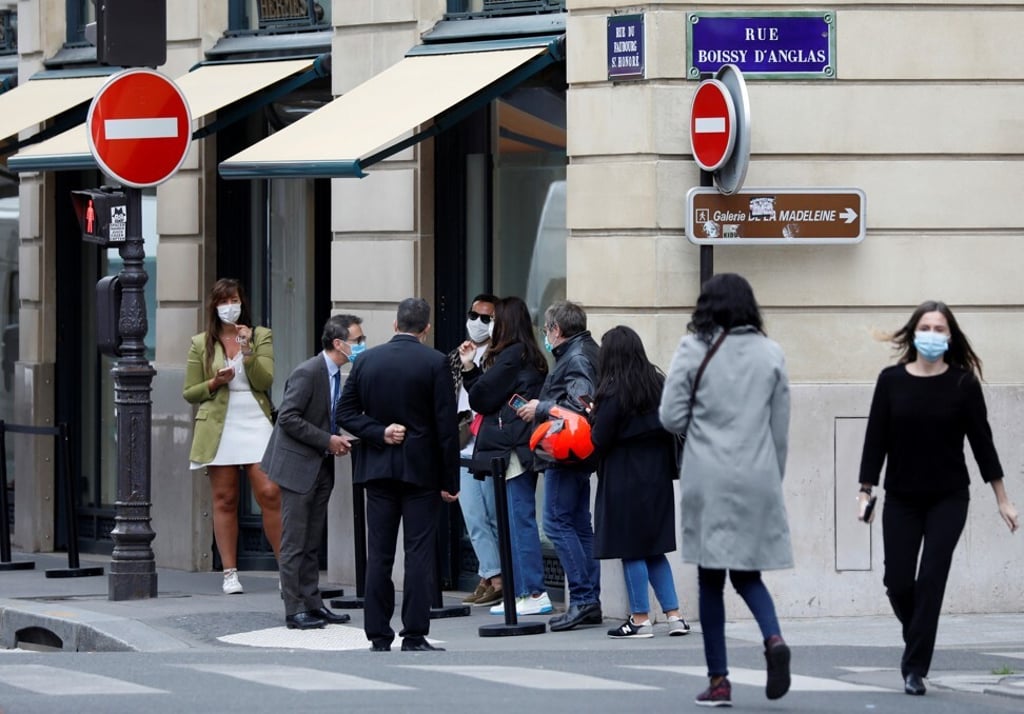Customers queue up at the reopened main shop of French luxury group Hermes in Paris. Photo: Reuters Customers queue up at the reopened main shop of French luxury group Hermes in Paris. Photo: Reuters