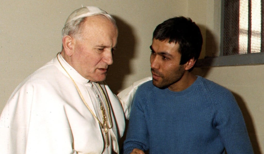 Pope John Paul II meets with his would-be assassin, Mehmet Ali Agca, in his prison cell in December 1983. Photo: Reuters