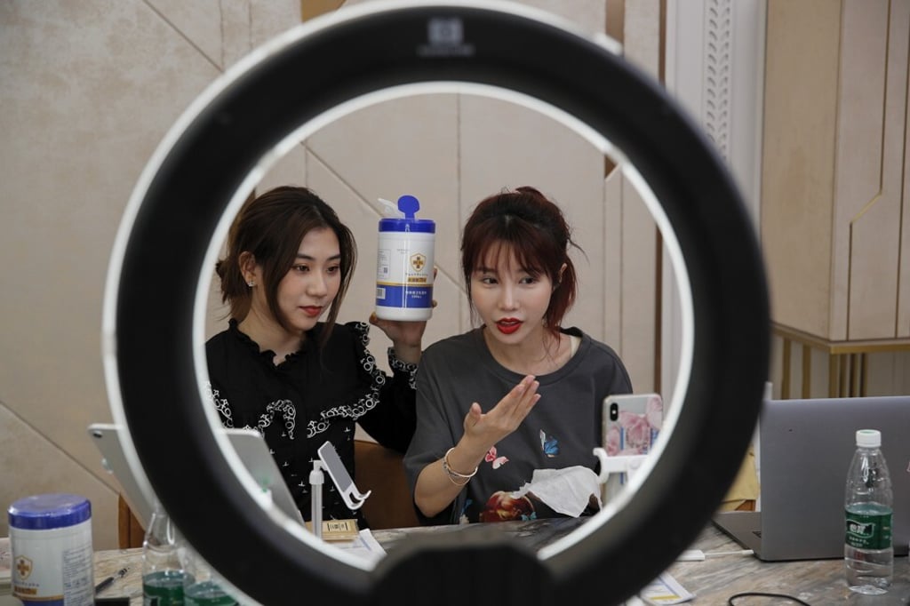 Zhang Mofan (right), an online celebrity, sells items like disinfectant wipes through live streaming at her house in Beijing. Photo: AP