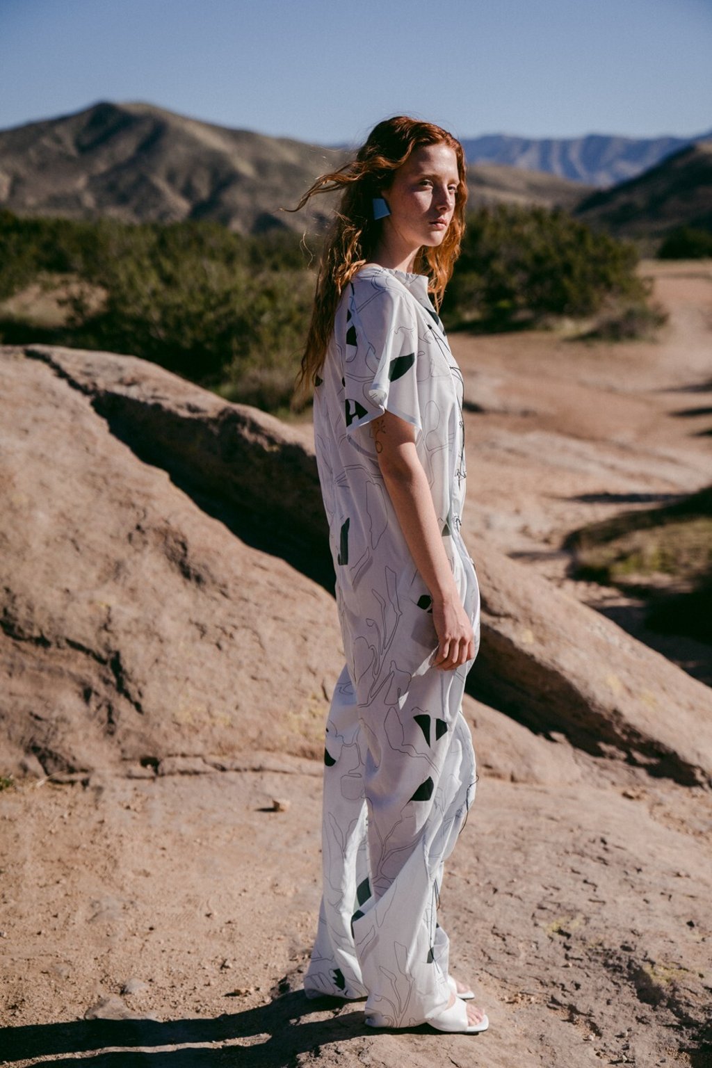 Chalayan jumpsuit; Yuul Yie sandals; Monies earrings, all prices on request Chalayan jumpsuit; Yuul Yie sandals; Monies earrings, all prices on request