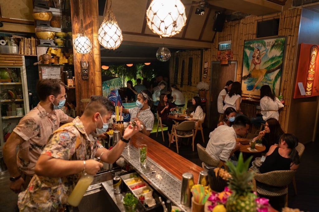 Customers gather at a bar in the Lan Kwai Fong nightlife area in Hong Kong on May 8 after curbs on social gathering were loosened. Photo: Bloomberg Customers gather at a bar in the Lan Kwai Fong nightlife area in Hong Kong on May 8 after curbs on social gathering were loosened. Photo: Bloomberg