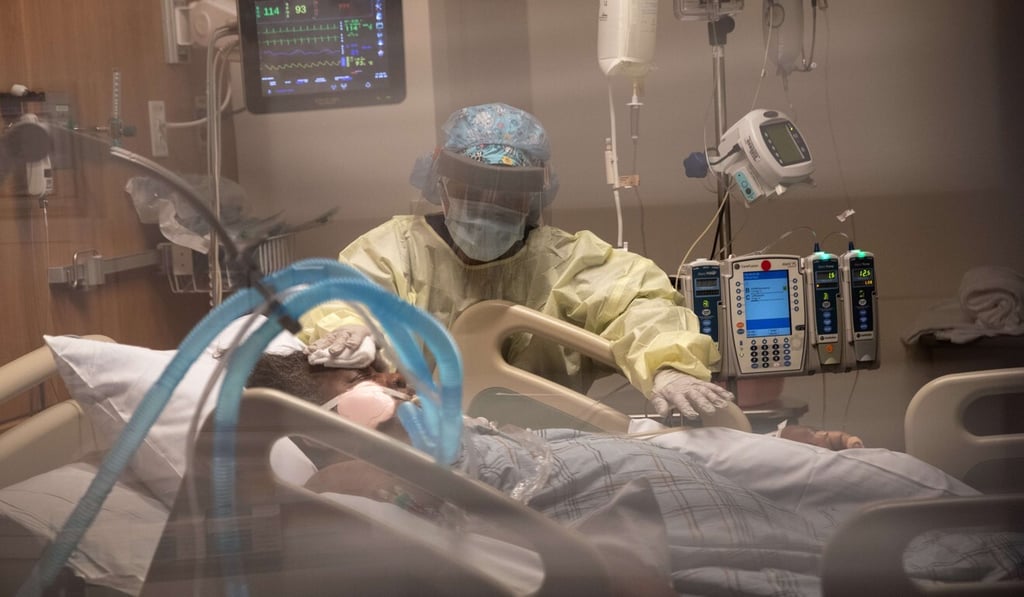 A nurse pictured with a Covid-19 patient on a ventilator in an intensive care unit in the United States. Photo: AFP
