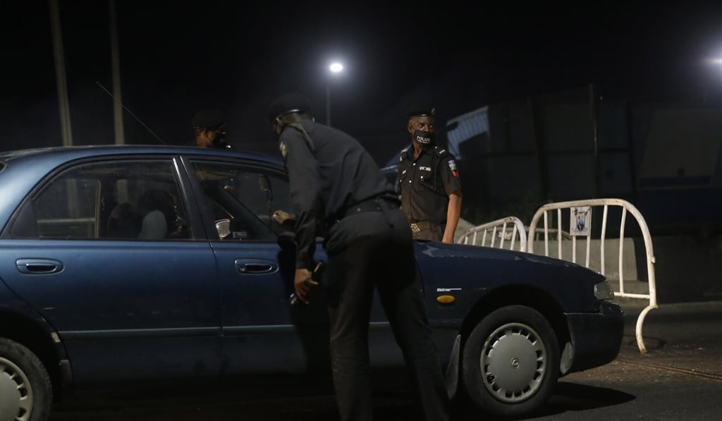 Police question people at a check point in Lagos earlier this month. Photo: AP