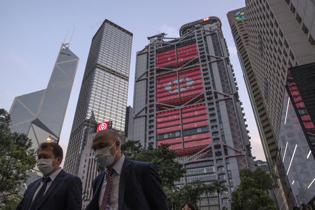 Pedestrians walk as the HSBC Holdings headquarters building, centre, stands illuminated in Hong Kong’s Central district on April 27. HSBC’s share of retail transactions in the city conducted digitally hit 94 per cent in March. Photo: Bloomberg Pedestrians walk as the HSBC Holdings headquarters building, centre, stands illuminated in Hong Kong’s Central district on April 27. HSBC’s share of retail transactions in the city conducted digitally hit 94 per cent in March. Photo: Bloomberg