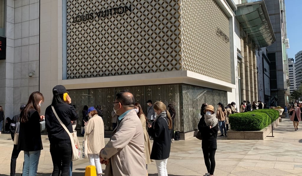 People queue to enter the Chanel boutique at a department store in Seoul this week. Photo: Reuters