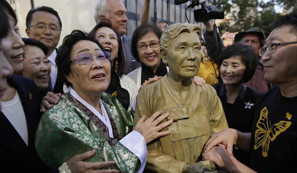 Lee Yong-soo next to a statue of Haksoon Kim in San Francisco. Haksoon Kim was the first to break the silence about comfort women in 1991. Photo: AP Lee Yong-soo next to a statue of Haksoon Kim in San Francisco. Haksoon Kim was the first to break the silence about comfort women in 1991. Photo: AP