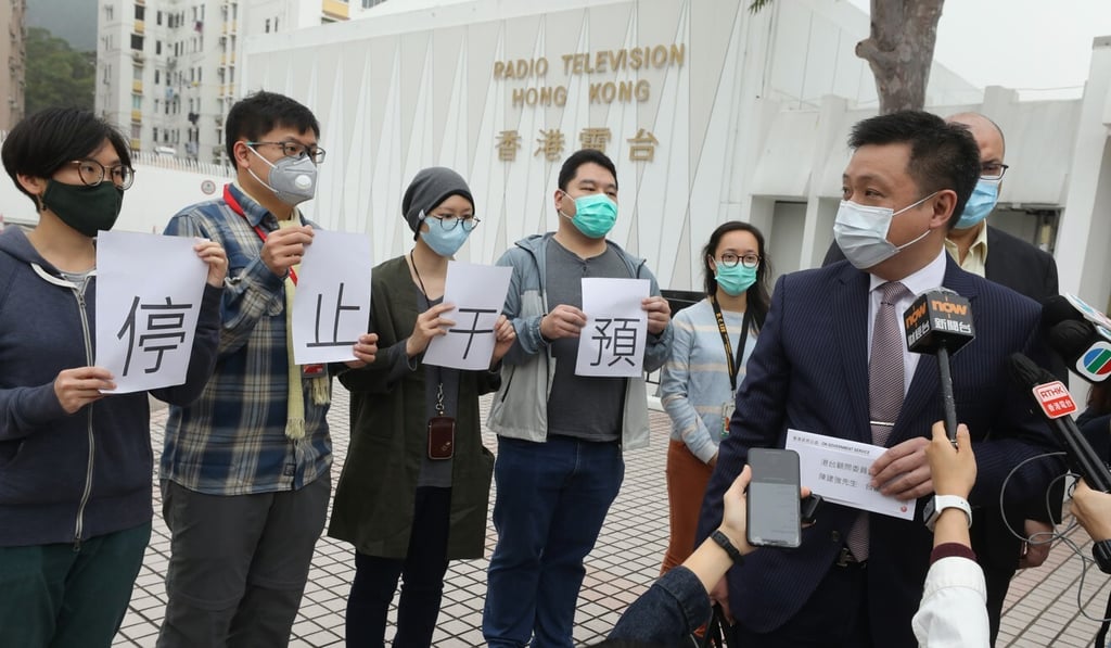 Dr Eugene Chan, chairman of RTHK’s Board of Advisors receives a letter from staff calling for intervention in their editorial decisions to stop outside the broadcaster’s headquarters in March. Photo: Dickson Lee