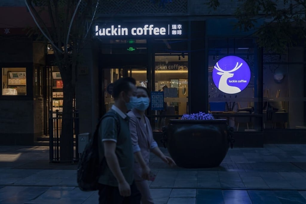 Pedestrians walk past a Luckin Coffee Inc. outlet in the Qianmen area of Beijing on May 20. Photo: Bloomberg Pedestrians walk past a Luckin Coffee Inc. outlet in the Qianmen area of Beijing on May 20. Photo: Bloomberg