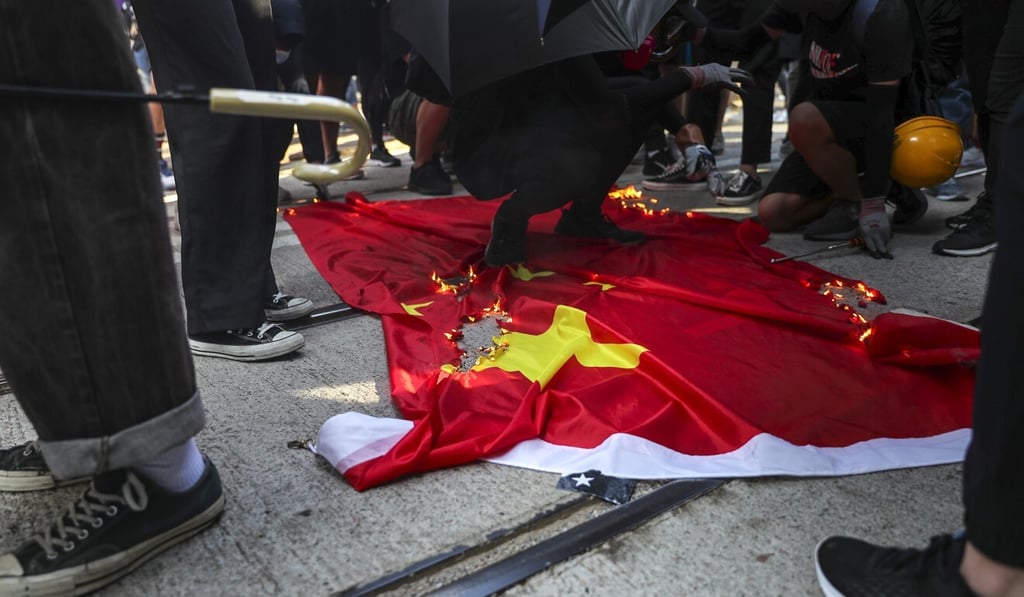 Protesters deface the Chinese national flag during an October 2019 demonstration in Central. Photo: Sam Tsang