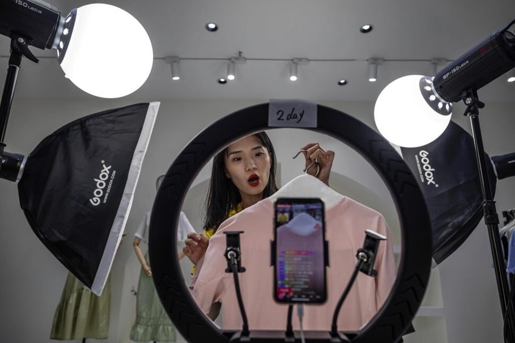A host presents goods for sale online in a studio in Guangzhou city, southern China, where the online retail market is one of the few sectors that has not suffered from the coronavirus pandemic. Photo: EPA-EFE
