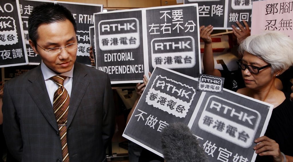 RTHK staff dressed in black wave placards to “receive” the new director of broadcasting, Roy Tang Yun-kwong, on September 15, 2011, as he arrives to start work at the broadcaster’s headquarters in Kowloon Tong. Photo: Handout RTHK staff dressed in black wave placards to “receive” the new director of broadcasting, Roy Tang Yun-kwong, on September 15, 2011, as he arrives to start work at the broadcaster’s headquarters in Kowloon Tong. Photo: Handout