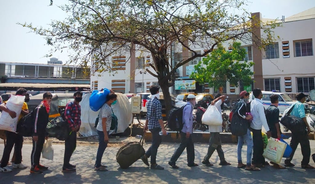 Migrant workers wait outside Mumbai’s Bandra Terminus railway station. A handful of special trains are being run to take migrant workers back to their hometowns. Photo: Kunal Purohit Migrant workers wait outside Mumbai’s Bandra Terminus railway station. A handful of special trains are being run to take migrant workers back to their hometowns. Photo: Kunal Purohit