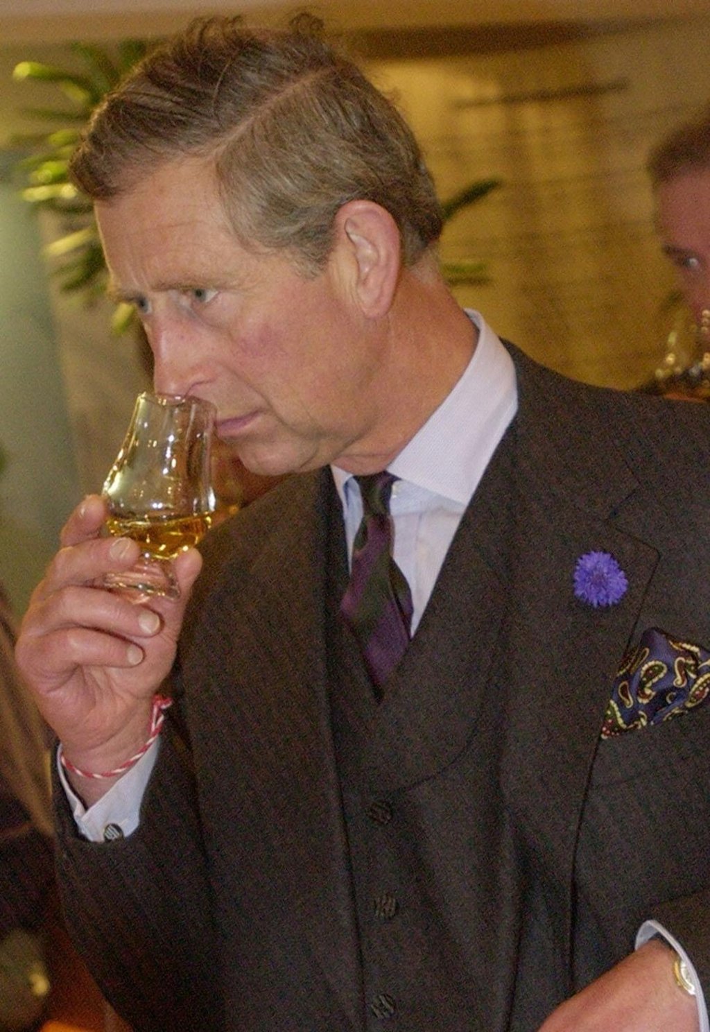 Britain’s Prince of Wales samples a dram of Ardbeg whiskey. Photo: Getty Images