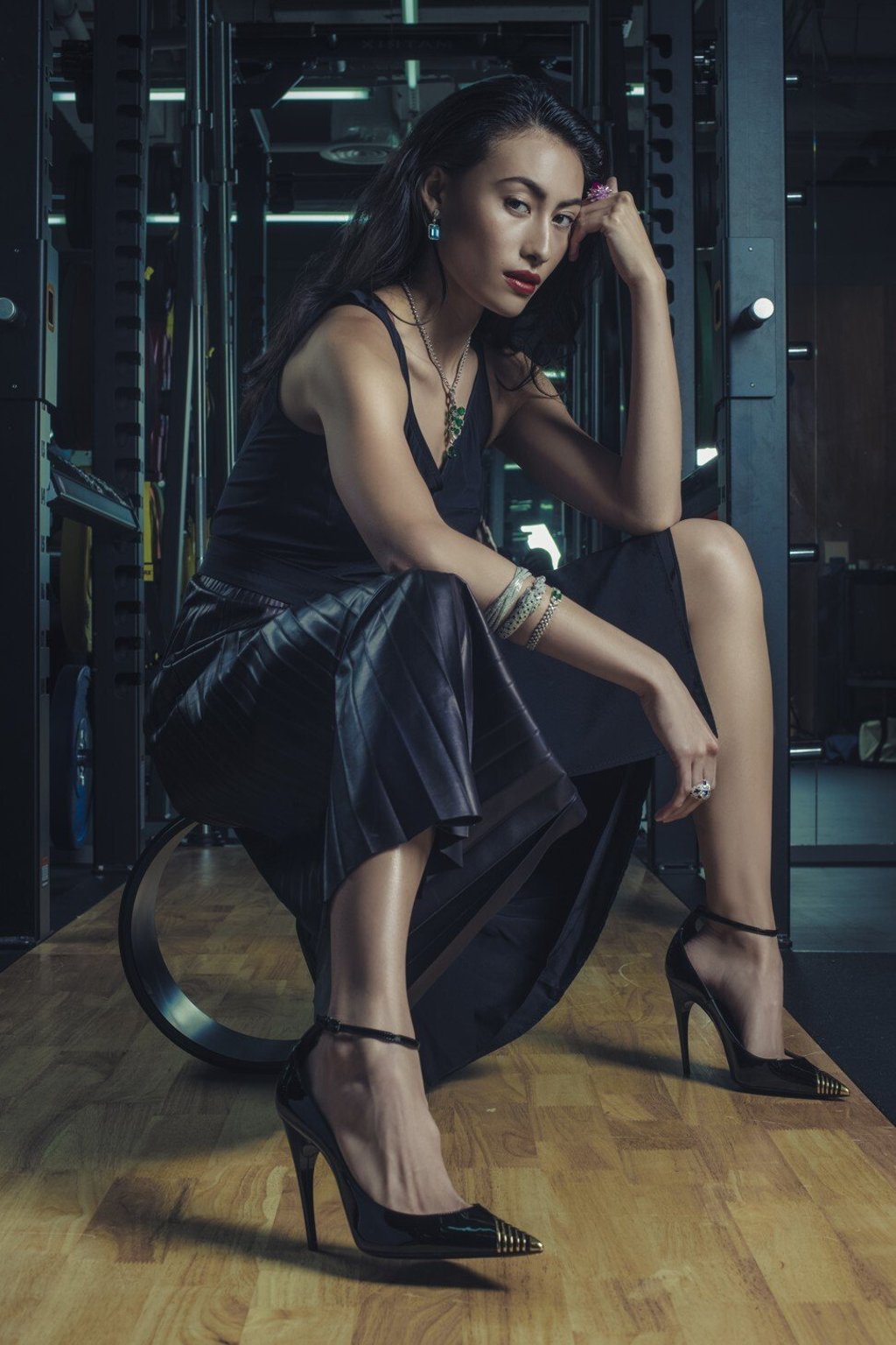 Tod’s dress, price on request; Saint Laurent shoes, price on request; Cartier necklace, bangle, and bracelet (centre and lower on right arm), prices on request; Tiffany & Co. earrings, HK$426,000; Tiffany & Co. bangle (upper on right arm), HK$568,000; Harry Winston ring (right hand), price on request; Piaget ring (left hand), HK$905,000.