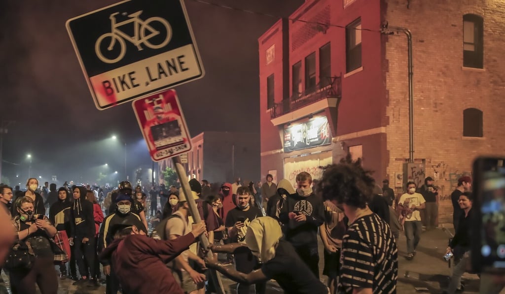 Protesters are seen outside the burning Minneapolis Police Department 3rd Precinct. Photo: EPA-EFE Protesters are seen outside the burning Minneapolis Police Department 3rd Precinct. Photo: EPA-EFE