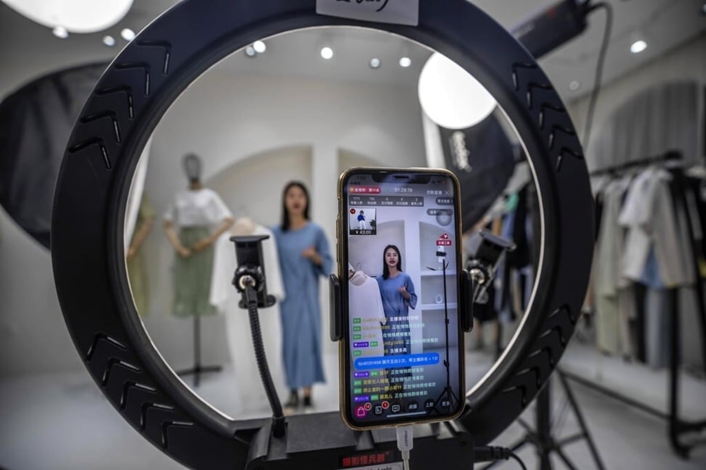 A host presents goods for sale online in the Gonoy Clothing Company studio in Guangzhou, China. Photo: EPA-EFE A host presents goods for sale online in the Gonoy Clothing Company studio in Guangzhou, China. Photo: EPA-EFE