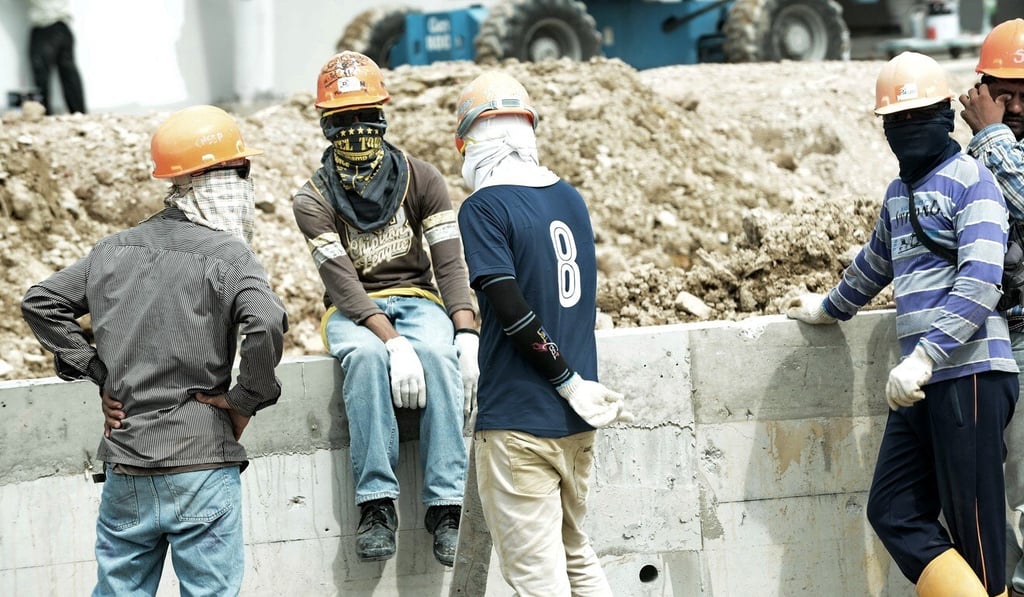 Foreign workers at a construction site in Singapore in 2014. Photo: AFP Foreign workers at a construction site in Singapore in 2014. Photo: AFP