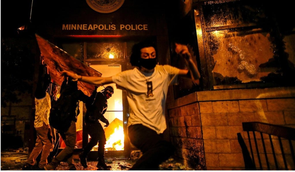 Protesters set fire to a police station in Minneapolis. Photo: Reuters