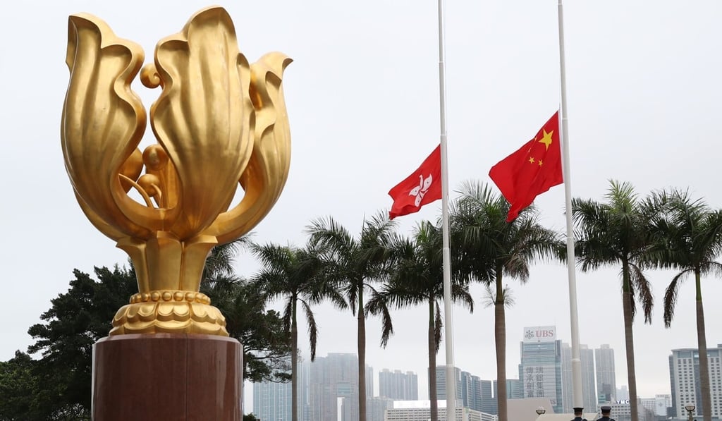 Paying respect to those killed by the coronavirus pandemic, the flags of Hong Kong and China are lowered during a ceremony in Wan Chai in April. Photo: Edmond So