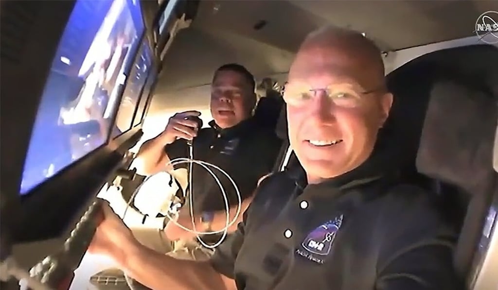 Nasa astronauts Doug Hurley (foreground) and Bob Behnken call down to mission controllers for a report on their second flight day on-board the SpaceX Crew Dragon spacecraft. Photo: Nasa via EPA-EFE Nasa astronauts Doug Hurley (foreground) and Bob Behnken call down to mission controllers for a report on their second flight day on-board the SpaceX Crew Dragon spacecraft. Photo: Nasa via EPA-EFE