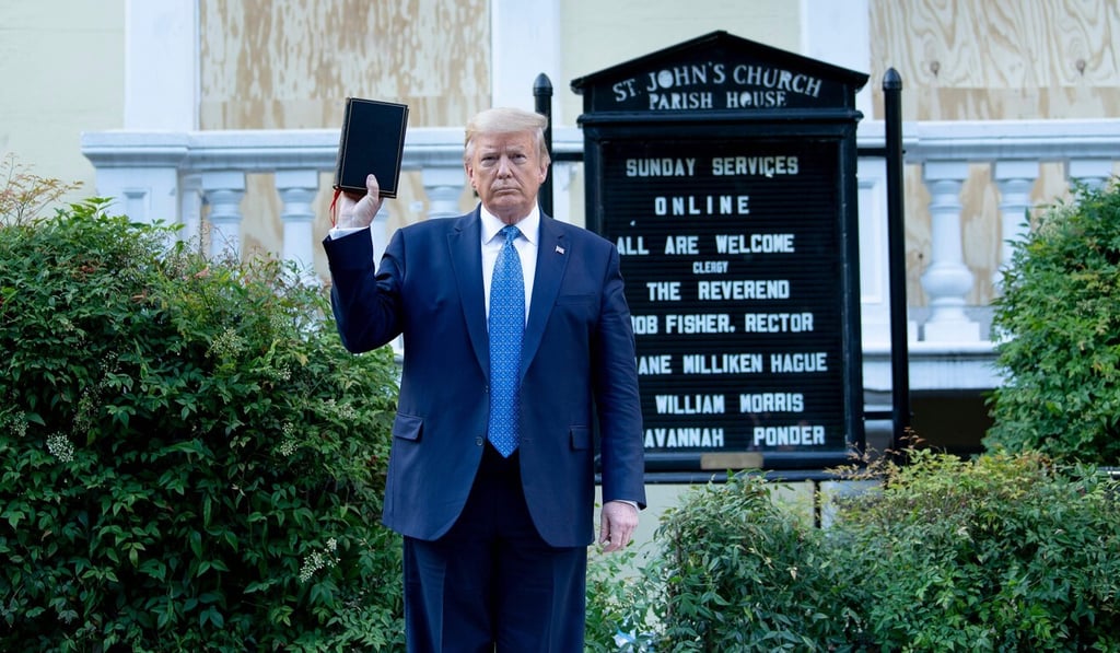 US President Donald Trump holds a Bible while visiting St John's Church across from the White House on Monday. Photo: AFP US President Donald Trump holds a Bible while visiting St John's Church across from the White House on Monday. Photo: AFP