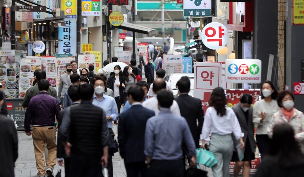 People pictured walking in the Myeongdong shopping district of Seoul on Tuesday. Photo: EPA People pictured walking in the Myeongdong shopping district of Seoul on Tuesday. Photo: EPA