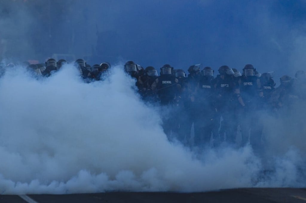Riot police officers walk through tear gas during a protest outside the 5th Police Precinct in Minneapolis, the United States, on May 30. Photo: Xinhua Riot police officers walk through tear gas during a protest outside the 5th Police Precinct in Minneapolis, the United States, on May 30. Photo: Xinhua