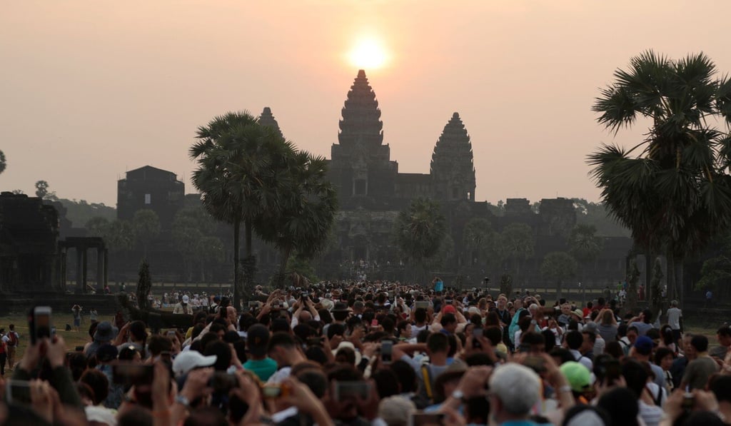 Thousands of tourists typically see the sun rise from behind the towers of Angkor Wat each dawn, but that number has fallen to a handful with international flights to Cambodia grounded amid the coronavirus pandemic. Photo: AFP
