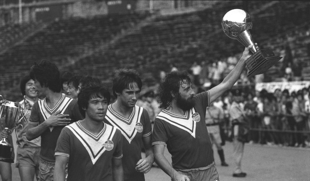 Seiko’s Derek Currie holds up the President-Chairman's Cup after their 2-0 win over USD in 1978. Photo: SCMP Seiko’s Derek Currie holds up the President-Chairman's Cup after their 2-0 win over USD in 1978. Photo: SCMP