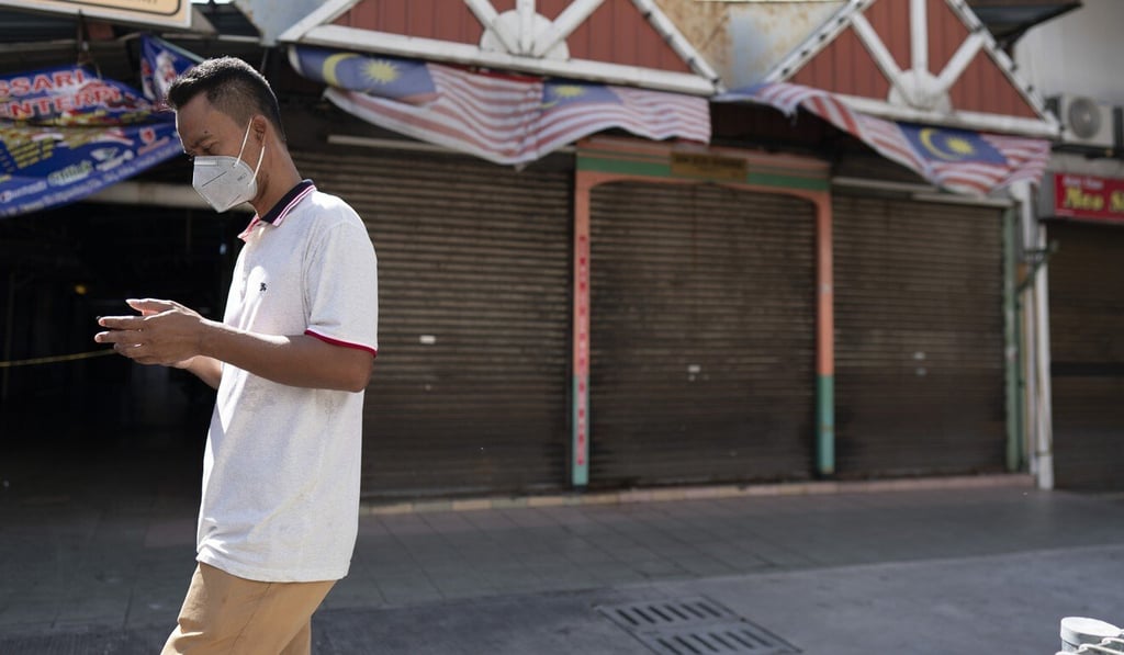 A man in Kuala Lumpur walks past closed stores on April 23, 2020, during the country’s restricted movement order. Photo: AP A man in Kuala Lumpur walks past closed stores on April 23, 2020, during the country’s restricted movement order. Photo: AP