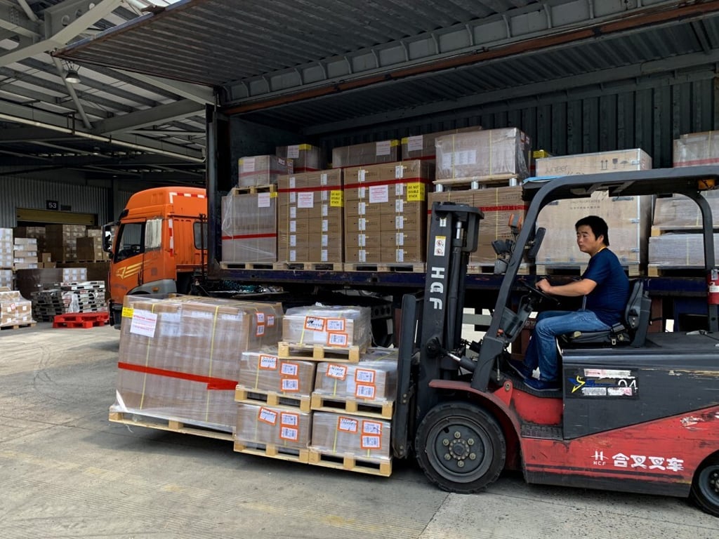 Forklift drivers move cartons of PPE goods to a cargo terminal at the Pudong International Airport before they go through a customs clearance process. Photo: Daniel Ren Forklift drivers move cartons of PPE goods to a cargo terminal at the Pudong International Airport before they go through a customs clearance process. Photo: Daniel Ren
